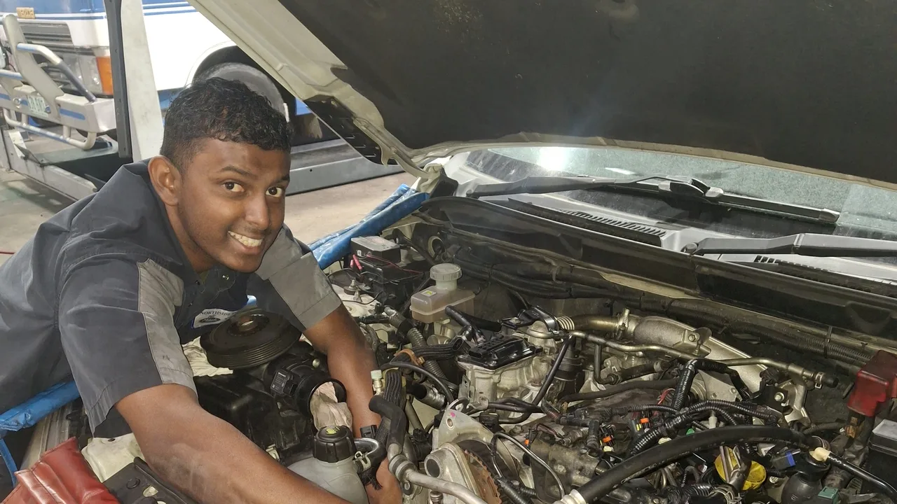 A Northside 4x4 technician working in a ute's engine bay