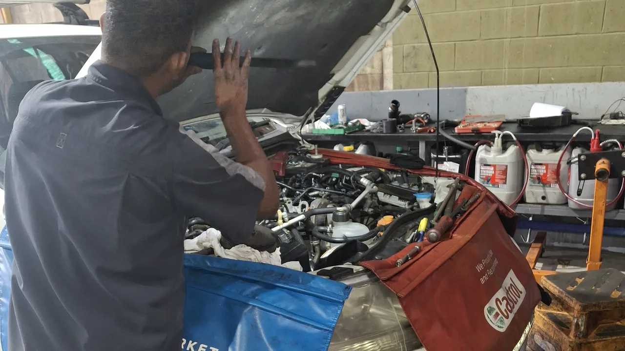 A Northside 4x4 technician checking under a bonnet